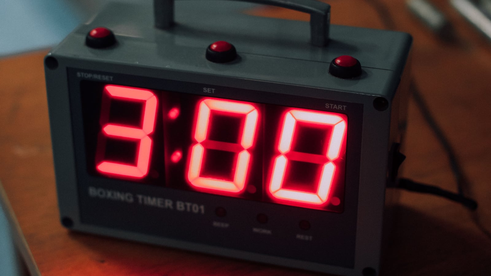 Close-up of an electronic timer with a red LED display sitting on a table